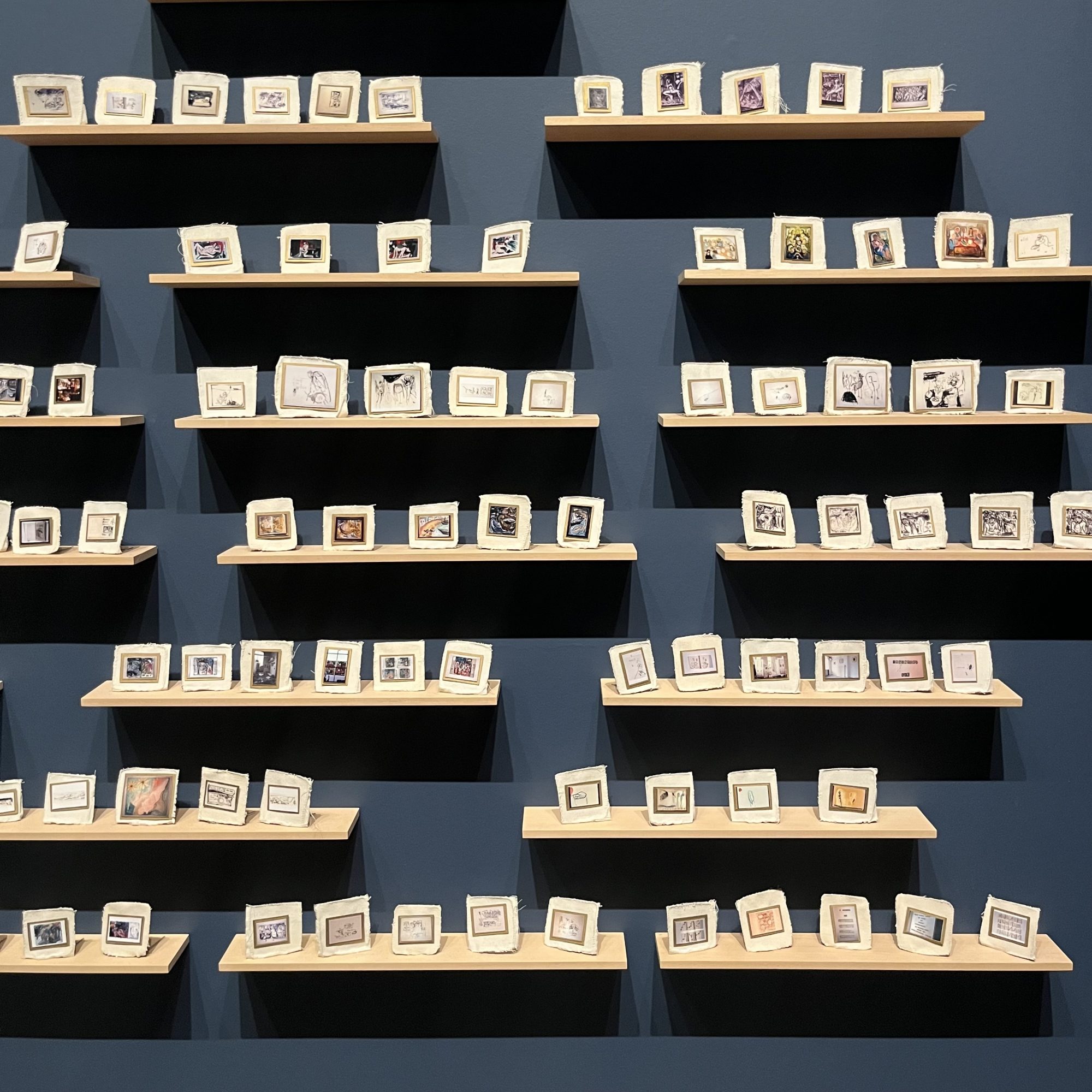 Alt text:
My Major Retrospective II by Tracey Emin. A grid of small personal photographs is mounted onto stitched white fabric, combining snapshots, handwritten fragments and intimate imagery into a densely arranged autobiographical installation.