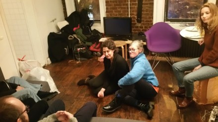 A performance work in the living room of the space, via Art Observed