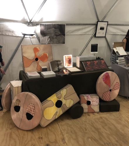 The Dispersed Holdings booth, with pillows by Merritt Meachem, via Art Observed